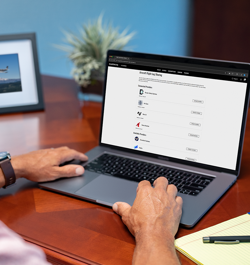 Pilot reviewing automatic flight log data on a tablet connected to Garmin G3X Touch avionics