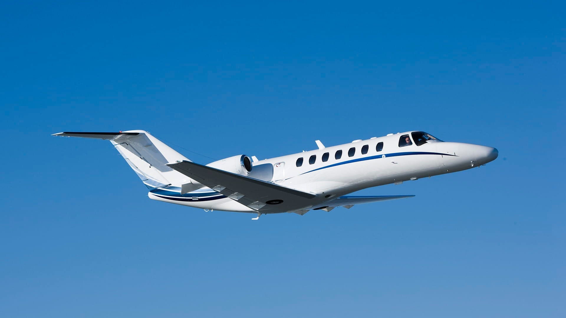 Cessna plane flying in the blue sky